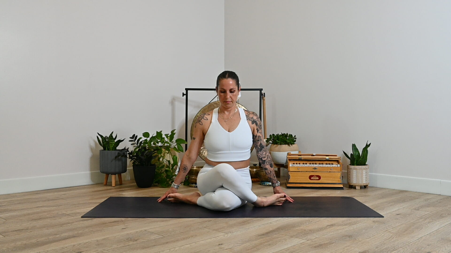 Michelle Young in white ALO in gomukasana pose